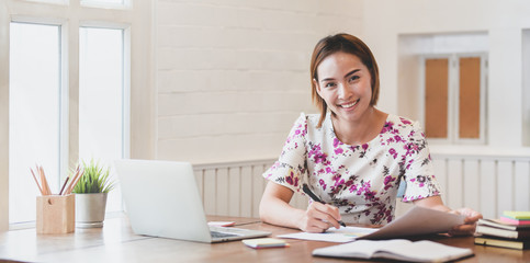 Beautiful young asian businesswoman smiling for camera