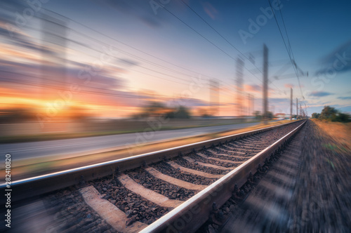 Fotografía Railroad and beautiful blue sky with clouds at sunset with motion blur effect in summer