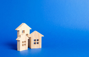 Three residential buildings figurine. The concept of buying and selling real estate, renting. Search for a Apartment house. Affordable housing, credit and loans. Urban Studies and Planning