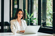 © bnenin - Portrait of a cheerful millennial business executive at modern workplace