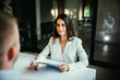© bnenin - Beautiful female financial advisor on a meeting with a client.