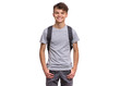 Leinwandbild Motiv Student teen boy with backpack looking at camera. Portrait of cute smiling schoolboy with hands in pockets, isolated on white background. Happy child Back to school.