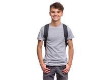 Student Teen Boy With Backpack Looking At Camera. Portrait Of Cute Smiling Schoolboy With Hands In Pockets, Isolated On White Background. Happy Child Back To School.