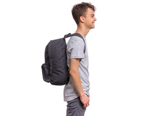 Poster - Student teen boy with backpack - side view. Portrait of cute smiling schoolboy with hands in pockets, isolated on white background. Happy child Back to school - profile.