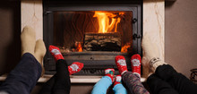 Family At Home. Feet In Socks Near Fireplace. Winter Holiday Concept