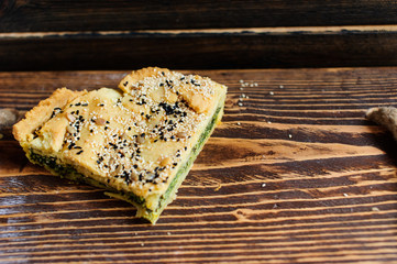 Wall Mural - Homemade spinach french pie on a white wooden board