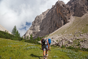 Wall Mural - some hikers walk along a mountain path.