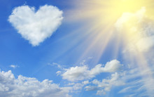 Heart Shaped Cloud In The Blue Sky And Sun