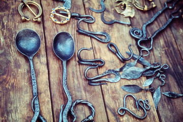 Forged jewelry for the kitchen and home of antique metal. Spoons, leaves and other vintage iron products, handmade.