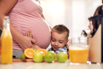 Canvas Print - Mother and her  son  making juice together