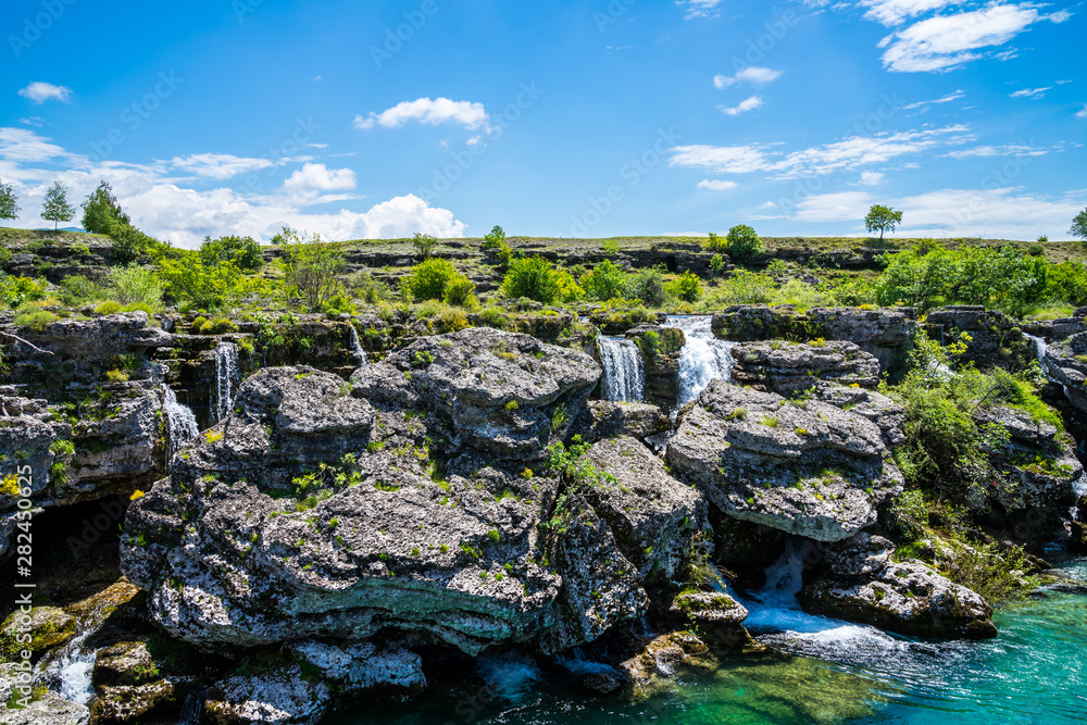 Obraz na płótnie Montenegro, Many waterfalls flowing down rocky green scenery at niagara falls landmark in podgorica nature landscape with blue sky w salonie