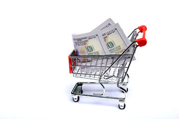 Wall Mural - Shopping cart with one hundred US dollar bills isolated on white background.