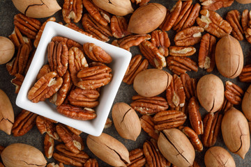 Wall Mural - White square bowl of pecan nuts. Healthy eating concept