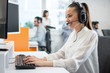 © Bojan - Friendly customer support operator with headset and microphone assisting to client in call centre