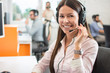 © Bojan - Portrait of beautiful friendly female customer services agent with headset working in call center