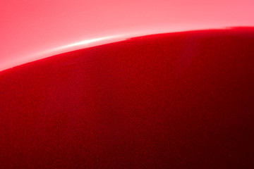 Close up detail of red metallic paint coating car body