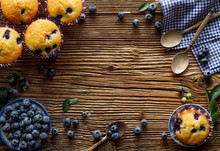 Blueberry Muffins And Fresh Blueberries On A Wooden, Rustic Background With Copy Space, Top View, Close-up. Concept About Blueberry Muffins