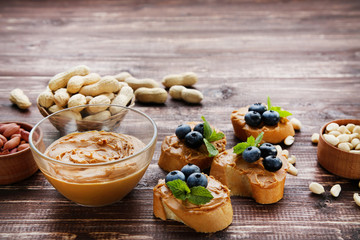 Poster - Bread with peanut butter, blueberries and nuts on wooden table