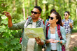 © Syda Productions - travel, tourism, hike and people concept - group of friends with map and backpacks in forest