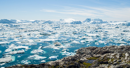 Wall Mural - Arctic nature landscape with icebergs in Greenland icefjord. Aerial drone photo image of ice and iceberg. Ilulissat Icefjord with icebergs from Jakobshavn Glacier aka Sermeq Kujalleq glacier.