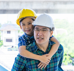 Wall Mural - Builder father is carrying his son on his back for father son connection concept