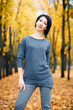 © soleg - Beautiful woman posing in autumn city park, fall season, yellow leaves