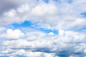 Wall Mural - low dense cumulus clouds in blue sky on summer day