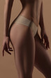 © Mirrorstudio - Thin young woman in underwear on beige background