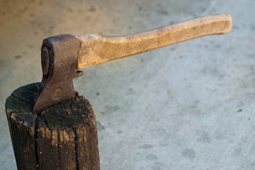 Old ax in old wooden chock