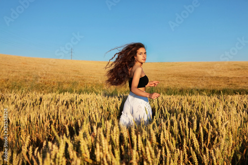 The Pretty Girl With Long Hair In Stylish White Pants And Black