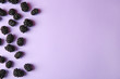 Tasty ripe blackberries on purple background, flat lay. Space for text