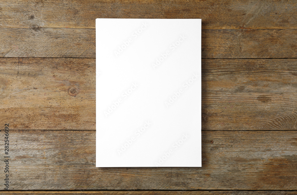 Stack of blank paper sheets for brochure on wooden background, top view. Mock up - obrazy, fototapety, plakaty 