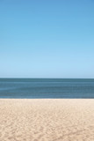 Fototapeta Morze - Sandy beach near sea on sunny summer day