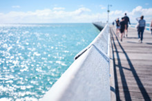 Uranagan Pier Hervey Bay With Blue Water And Blue Sky With People Walking Along It