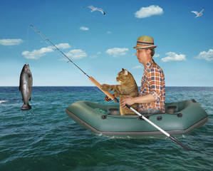 Wall Mural - The fisherman im a straw hat with his cat is fishing in the rubber boat in the sea. They caught a big fish.