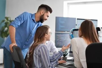 Wall Mural - team of programmers working in office