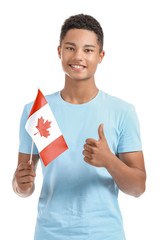 Wall Mural - African-American teenage boy with Canadian flag on white background