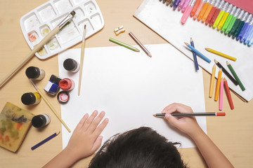 child drawing on paper