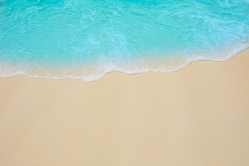 Soft waves of blue sea on the Maldives beach for the background.