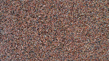Texture Of A Colorful Sand Wall With Red, Brown Dark Sandstones