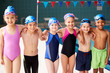 © Monkey Business - Portrait Of Children Standing On Edge Of Pool Waiting For Swimming Lesson