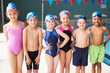 © Monkey Business - Portrait Of Children Standing On Edge Of Pool Waiting For Swimming Lesson