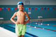 © Monkey Business - Portrait Of Boy Standing By Edge Of Swimming Pool Ready For Lesson