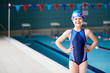 © Monkey Business - Portrait Of Girl Standing By Edge Of Swimming Pool Ready For Lesson