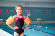 © Monkey Business - Portrait Of Girl Wearing Armbands Standing By Edge Of Swimming Pool Ready For Lesson