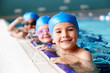 © Monkey Business - Portrait Of Children In Water At Edge Of Pool Waiting For Swimming Lesson