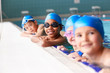 © Monkey Business - Portrait Of Children In Water At Edge Of Pool Waiting For Swimming Lesson