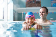 © Monkey Business - Male Swimming Coach Giving Girl Holding Float One To One Lesson In Pool