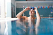 © Monkey Business - Male Swimmer Wearing Hat And Goggles Training In Swimming Pool