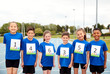 © Monkey Business - Portrait Of Children On Athletics Track Wearing Competitor Numbers On Sports Day